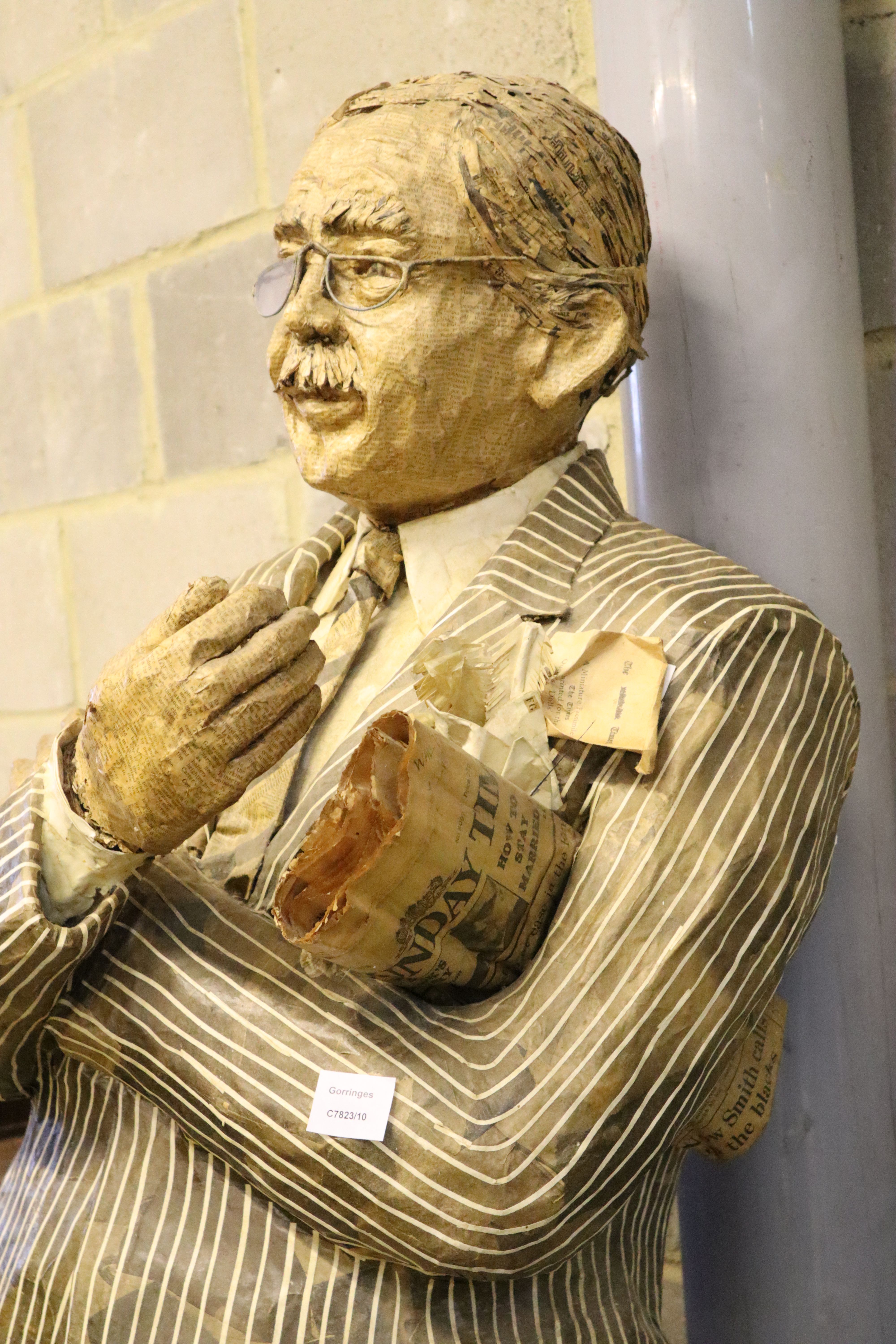 A stuffed papier mache figure of a gentleman holding the Sunday Times, height 170cm